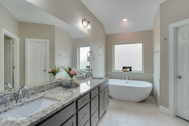 606 Labarre Ln, Bossier City, LA 71111 - bathroom with a soaking tub, double vanity, tile patterned floors, and vaulted ceiling