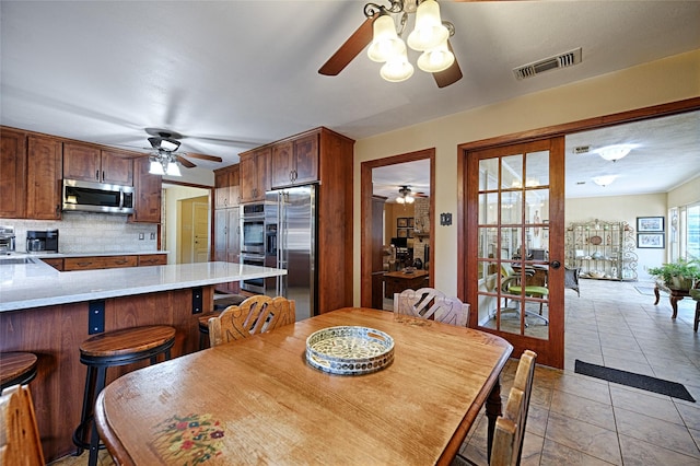 2112 Columbia Dr, Richardson, TX 75081 - dining area featuring ceiling fan and light tile patterned flooring