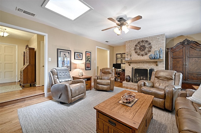 2112 Columbia Dr, Richardson, TX 75081 - living room with wood finished floors, ceiling fan, and a fireplace