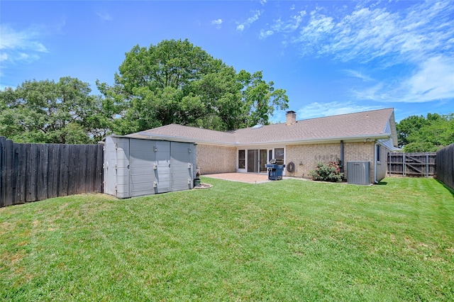 2112 Columbia Dr, Richardson, TX 75081 - back of house featuring brick siding, central AC, a patio area, a chimney, and an outbuilding