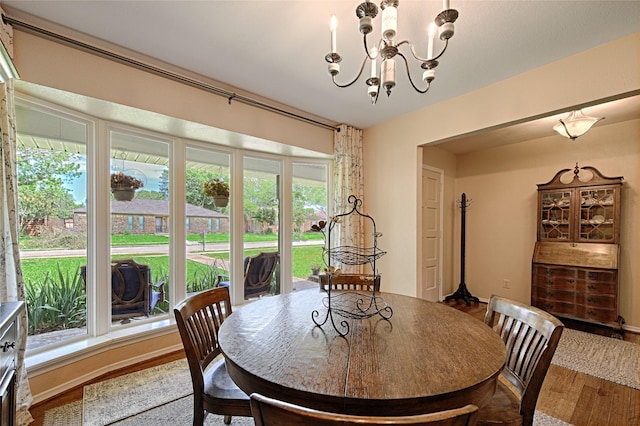 2112 Columbia Dr, Richardson, TX 75081 - dining area featuring wood finished floors and a chandelier