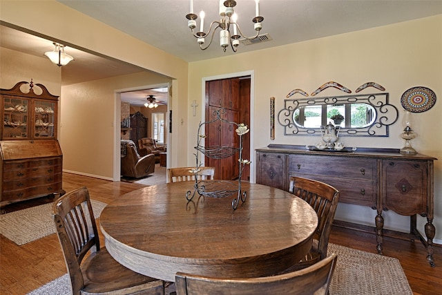 2112 Columbia Dr, Richardson, TX 75081 - dining room featuring wood finished floors, a chandelier, baseboards, and ceiling fan