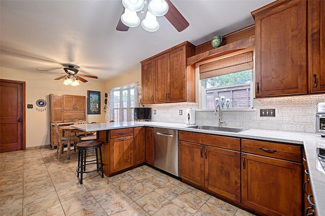 2112 Columbia Dr, Richardson, TX 75081 - kitchen featuring stainless steel dishwasher, a sink, ceiling fan, a peninsula, and decorative backsplash