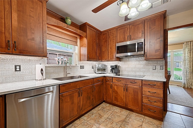 2112 Columbia Dr, Richardson, TX 75081 - kitchen with stainless steel appliances, a sink, light countertops, and plenty of natural light
