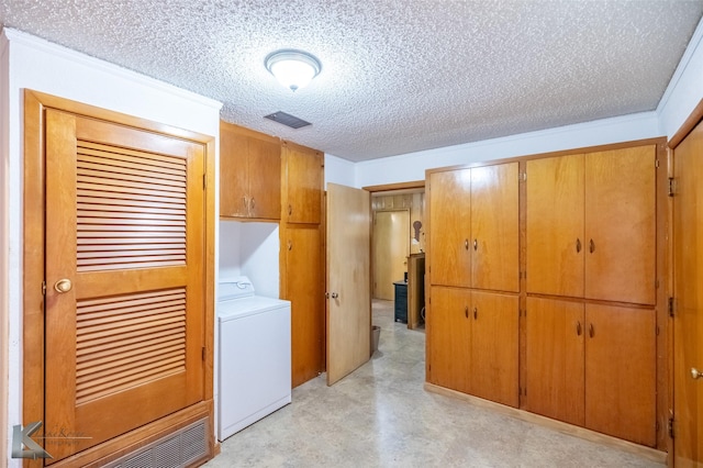 2757 Old Anson Rd, Abilene, TX 79603 - laundry area with washer / dryer, cabinet space, and a textured ceiling