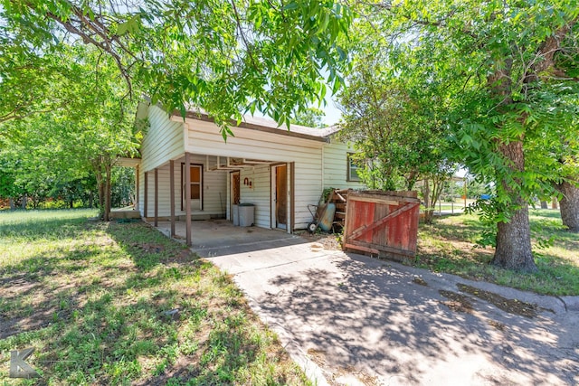 2757 Old Anson Rd, Abilene, TX 79603 - garage with concrete driveway and an attached carport
