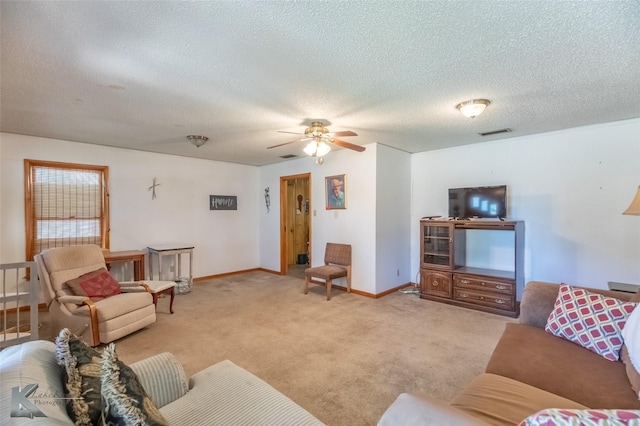 2757 Old Anson Rd, Abilene, TX 79603 - living area with ceiling fan, light colored carpet, a textured ceiling, and baseboards