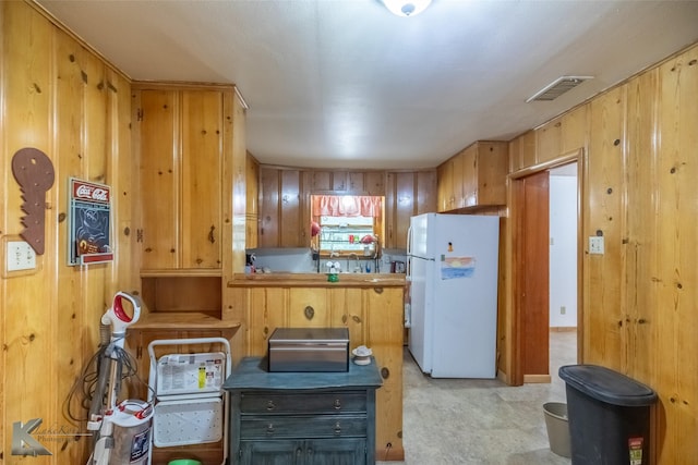 2757 Old Anson Rd, Abilene, TX 79603 - kitchen with freestanding refrigerator and wooden walls