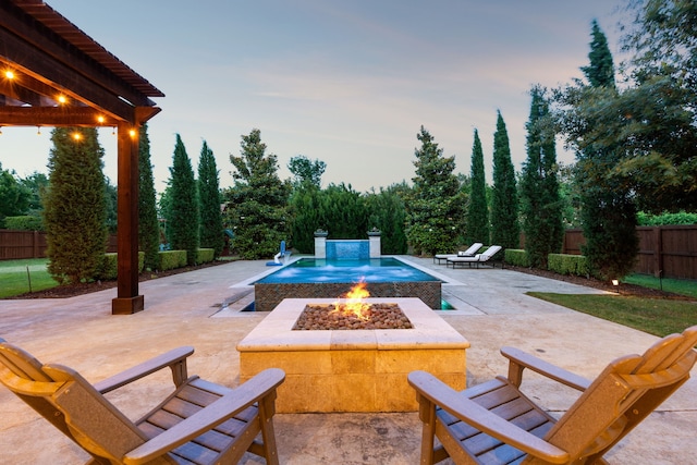2509 Oak Bend Ct, Southlake, TX 76092 - pool at dusk with a fire pit and a patio area