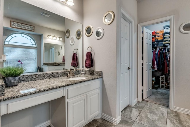 249 Noble Nest Dr, Midlothian, TX 76065 - bathroom featuring vanity, baseboards, and a spacious closet