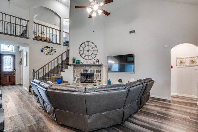 249 Noble Nest Dr, Midlothian, TX 76065 - living area featuring ceiling fan, arched walkways, high vaulted ceiling, wood finished floors, and baseboards