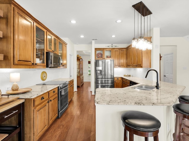 2525 Still Springs Dr, Little Elm, TX 75068 - kitchen with stainless steel fridge, electric range oven, a sink, brown cabinetry, and recessed lighting
