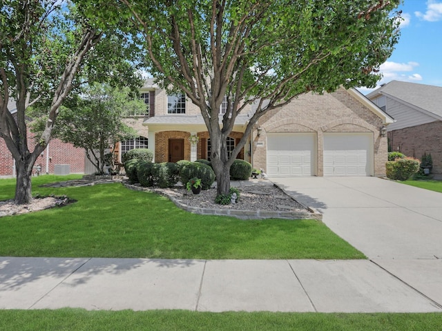 2525 Still Springs Dr, Little Elm, TX 75068 - view of front facade featuring brick siding, a garage, a front yard, and concrete driveway