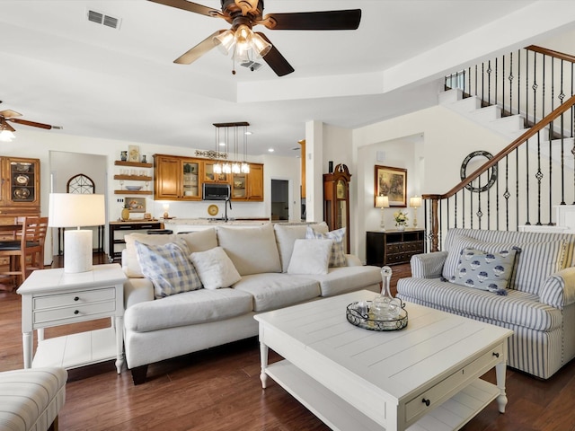 2525 Still Springs Dr, Little Elm, TX 75068 - living area with ceiling fan, dark wood-type flooring, stairway, and a raised ceiling