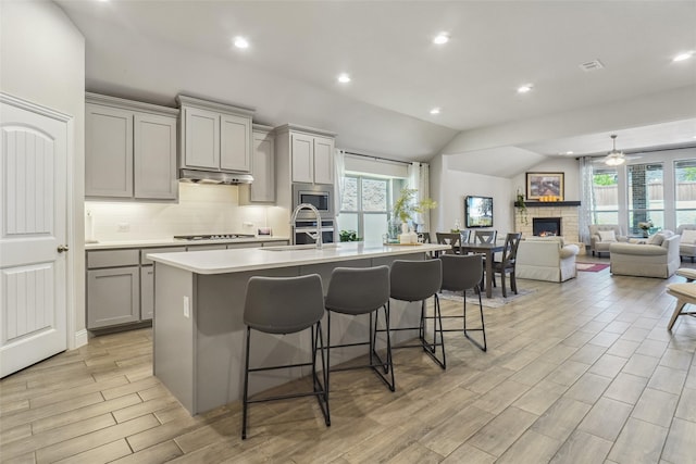 444 Oliver Ct, Argyle, TX 76226 - kitchen featuring gray cabinets, a sink, stainless steel appliances, an island with sink, and light countertops