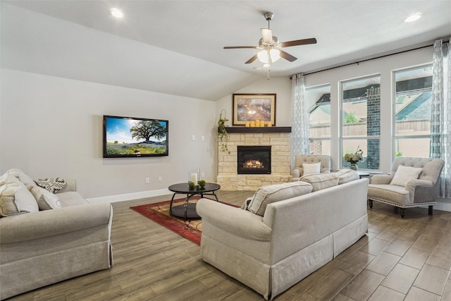 444 Oliver Ct, Argyle, TX 76226 - living room featuring a ceiling fan, wood finished floors, baseboards, lofted ceiling, and a stone fireplace