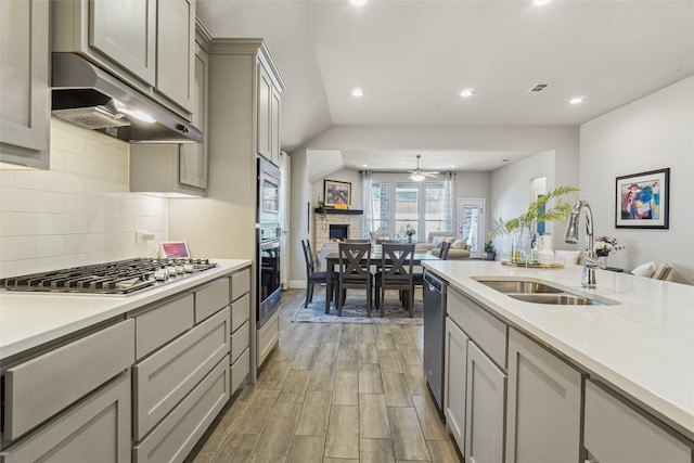 444 Oliver Ct, Argyle, TX 76226 - kitchen with a sink, open floor plan, stainless steel appliances, under cabinet range hood, and gray cabinetry