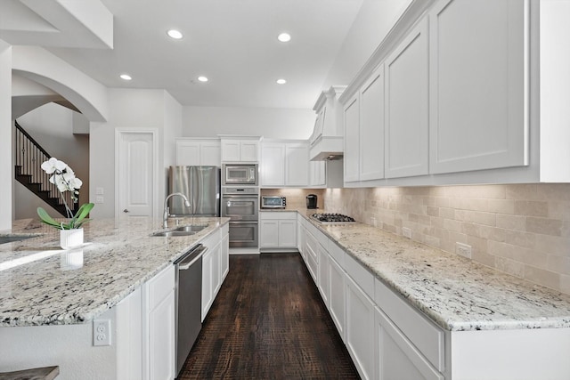 2812 Cedar Elm Dr, Carrollton, TX 75010 - kitchen with appliances with stainless steel finishes, white cabinets, a sink, recessed lighting, and light stone countertops