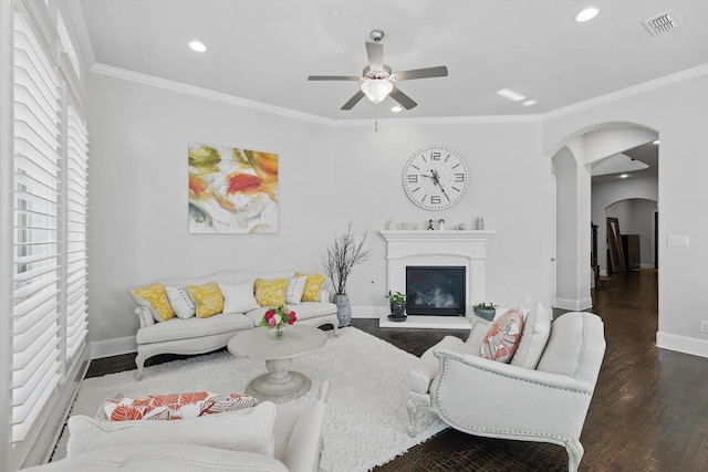 2812 Cedar Elm Dr, Carrollton, TX 75010 - living area with arched walkways, ceiling fan, wood finished floors, baseboards, and ornamental molding