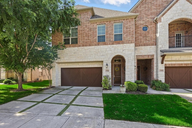 2812 Cedar Elm Dr, Carrollton, TX 75010 - view of front facade featuring an attached garage, concrete driveway, stone siding, a front yard, and brick siding