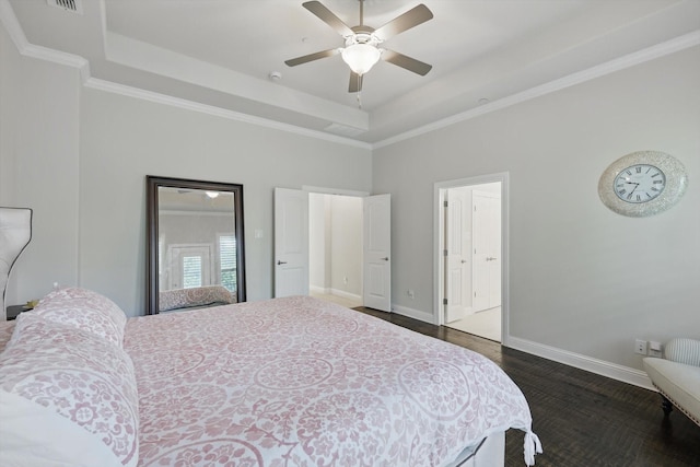 2812 Cedar Elm Dr, Carrollton, TX 75010 - bedroom featuring a raised ceiling, a towering ceiling, baseboards, dark wood finished floors, and crown molding