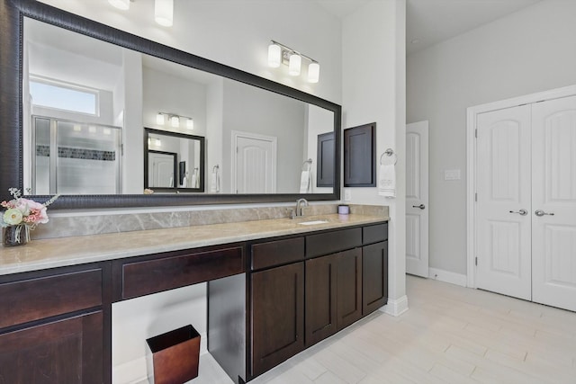 2812 Cedar Elm Dr, Carrollton, TX 75010 - full bathroom featuring vanity, a stall shower, a closet, and baseboards