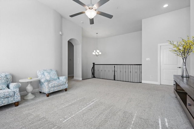 2812 Cedar Elm Dr, Carrollton, TX 75010 - sitting room with ceiling fan, a chandelier, carpet, arched walkways, and baseboards