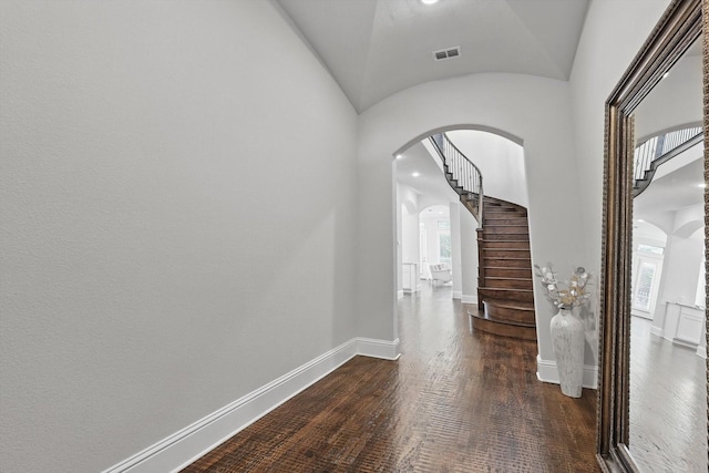 2812 Cedar Elm Dr, Carrollton, TX 75010 - hall with arched walkways, lofted ceiling, baseboards, and wood finished floors