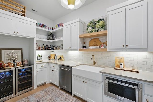 5913 Preston Way, Colleyville, TX 76034 - kitchen with open shelves, a sink, stainless steel dishwasher, light countertops, and light wood-type flooring