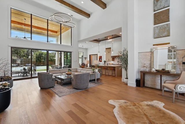 5913 Preston Way, Colleyville, TX 76034 - living area with a high ceiling, light wood finished floors, and beamed ceiling