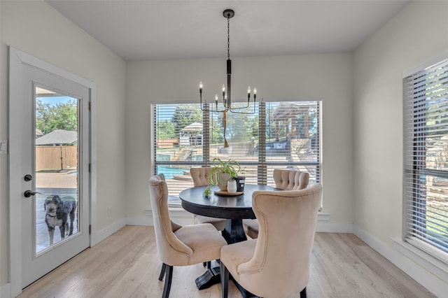 125 Wood Bend Ct, Weatherford, TX 76087 - dining space with a chandelier, light wood-style floors, and baseboards