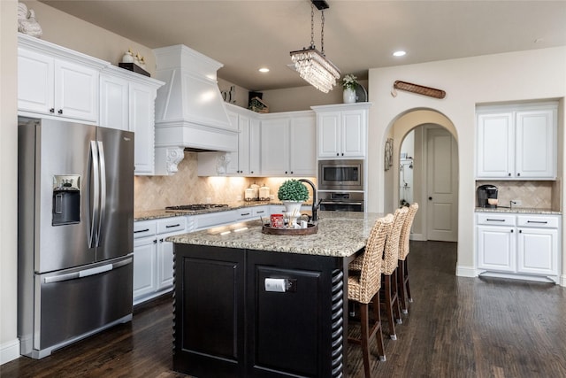 931 Champions Way, Roanoke, TX 76262 - kitchen featuring appliances with stainless steel finishes, custom exhaust hood, white cabinets, dark wood finished floors, and recessed lighting