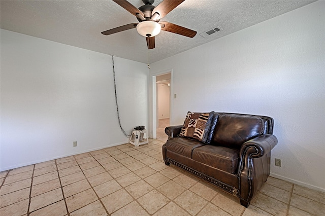 1705 Savoy St, Dallas, TX 75224 - sitting room featuring ceiling fan, a textured ceiling, baseboards, and light tile patterned floors