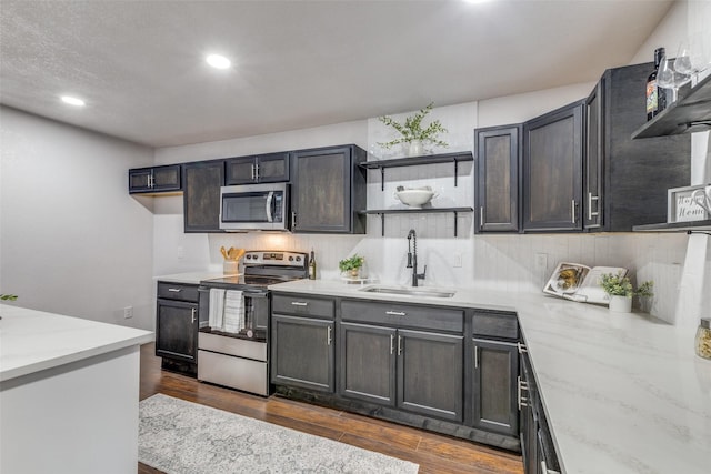 3321 NW 31st St, Fort Worth, TX 76106 - kitchen featuring stainless steel appliances, a sink, open shelves, dark wood-type flooring, and recessed lighting