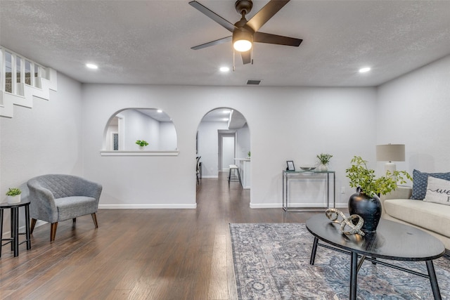 3321 NW 31st St, Fort Worth, TX 76106 - living room featuring ceiling fan, wood finished floors, arched walkways, recessed lighting, and a textured ceiling