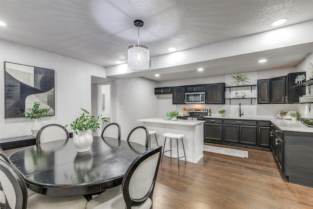 3321 NW 31st St, Fort Worth, TX 76106 - dining area with dark wood-style floors, recessed lighting, and a textured ceiling