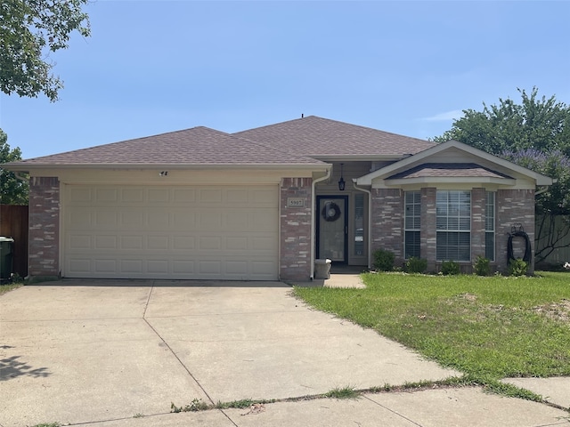 5907 Aloe Ct, Arlington, TX 76017 - ranch-style home featuring brick siding, concrete driveway, a garage, and a front yard