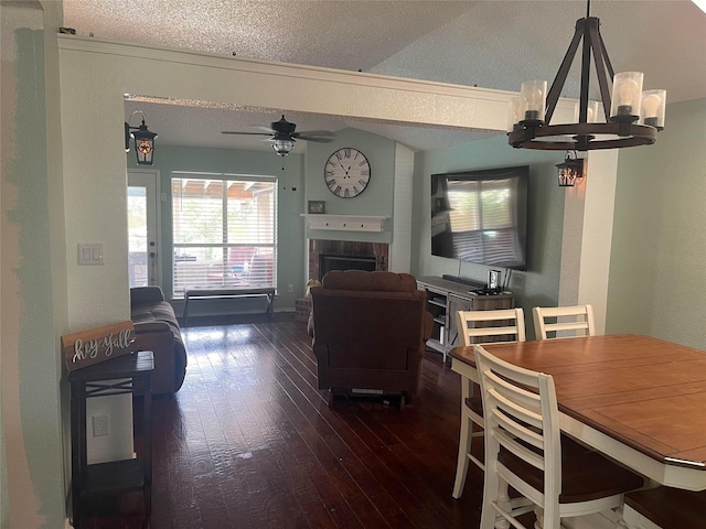 5907 Aloe Ct, Arlington, TX 76017 - living area with wood-type flooring, a chandelier, a textured ceiling, a fireplace, and ceiling fan