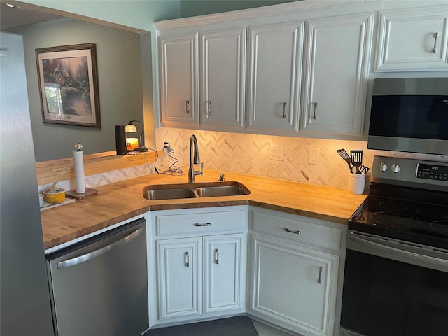 5907 Aloe Ct, Arlington, TX 76017 - kitchen with stainless steel appliances, wood counters, decorative backsplash, and white cabinetry