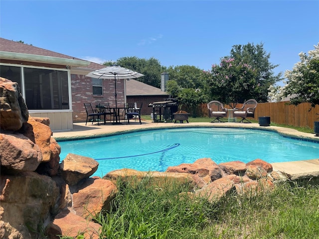 5907 Aloe Ct, Arlington, TX 76017 - view of swimming pool with a fenced backyard, a sunroom, and a patio area