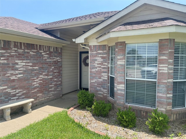 5907 Aloe Ct, Arlington, TX 76017 - view of exterior entry with brick siding and roof with shingles
