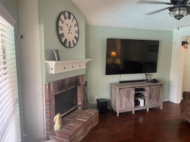 5907 Aloe Ct, Arlington, TX 76017 - living area with wood finished floors, a ceiling fan, a brick fireplace, and a textured ceiling