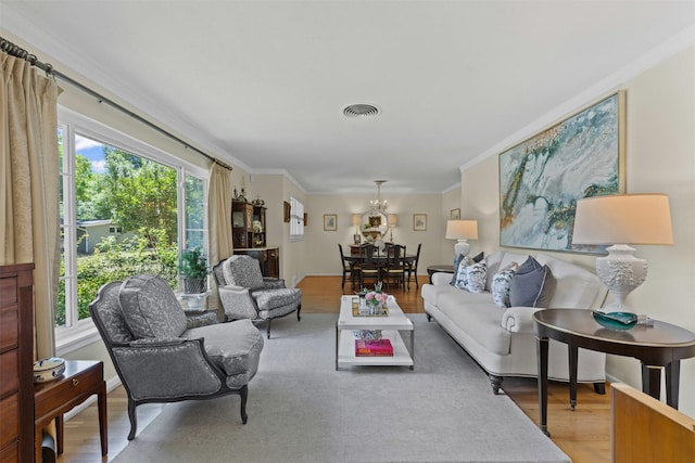 4304 Warnock Ct, Fort Worth, TX 76109 - living area with light wood finished floors, crown molding, and a chandelier