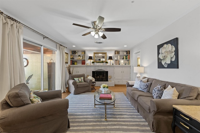 4304 Warnock Ct, Fort Worth, TX 76109 - living area with ceiling fan, wood finished floors, and a brick fireplace