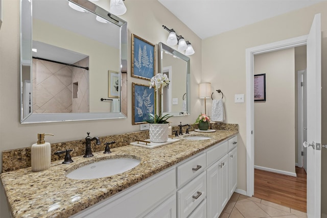 4304 Warnock Ct, Fort Worth, TX 76109 - full bath with double vanity, tile patterned floors, a tile shower, and baseboards