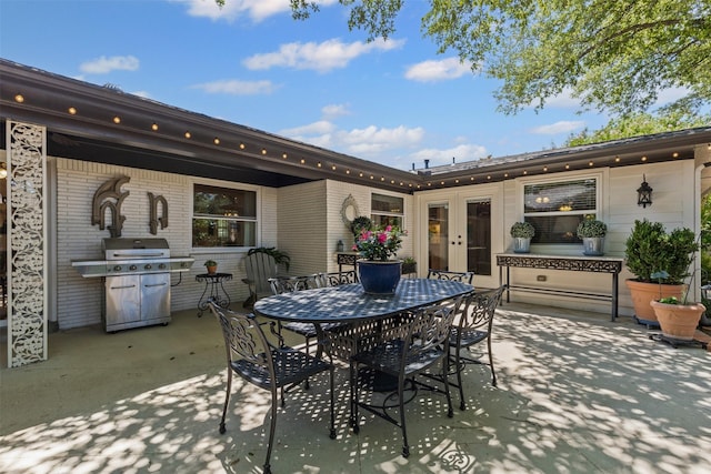 4304 Warnock Ct, Fort Worth, TX 76109 - view of patio / terrace with a grill, outdoor dining space, and french doors