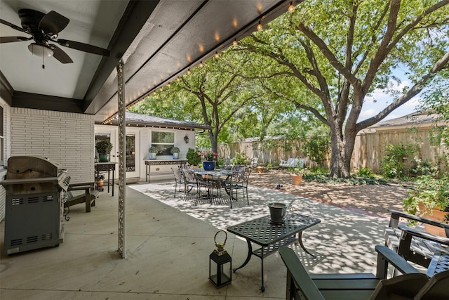 4304 Warnock Ct, Fort Worth, TX 76109 - fenced backyard featuring outdoor dining space, a ceiling fan, a patio, and grilling area