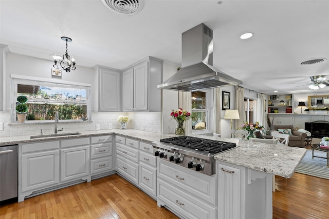 4304 Warnock Ct, Fort Worth, TX 76109 - kitchen featuring stainless steel appliances, island exhaust hood, a sink, a chandelier, and healthy amount of natural light
