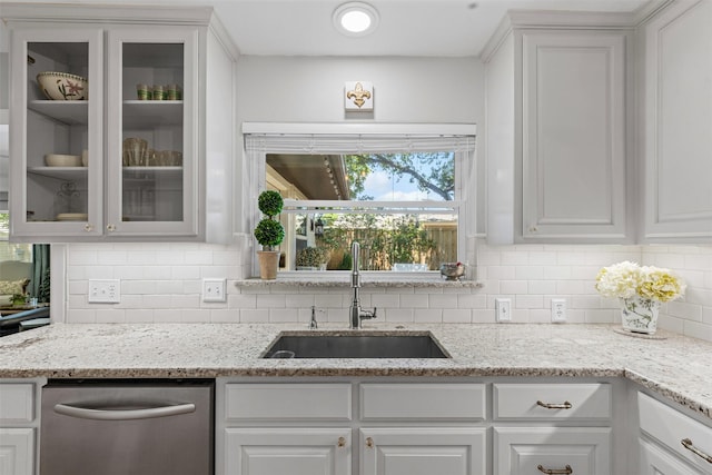 4304 Warnock Ct, Fort Worth, TX 76109 - kitchen with a sink, stainless steel dishwasher, glass insert cabinets, and backsplash