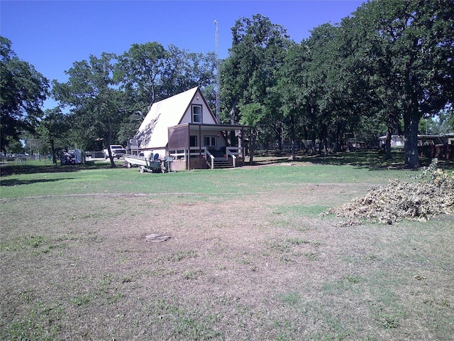 999 Roberts Cut Off Rd, Bowie, TX 76230 - view of green lawn with covered porch and view of wooded area